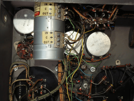 Close-up view of internal components including wires, capacitors, and circuit boards in an electronic device.