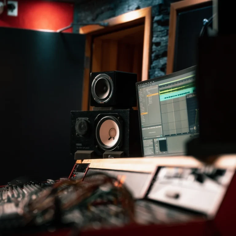 Studio monitors and the DAW screen on the mastering desk in the Sonic Studio control room