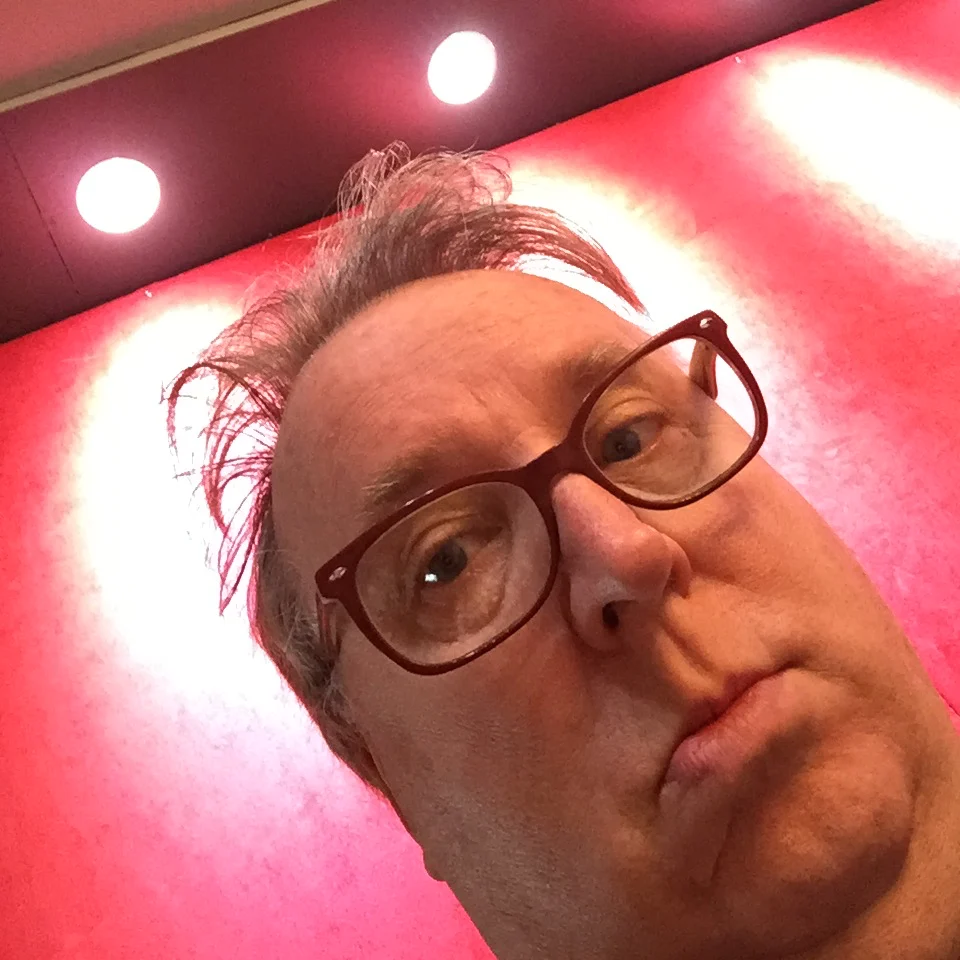 Christopher Cash under the red studio lights at Sonic-Rocket