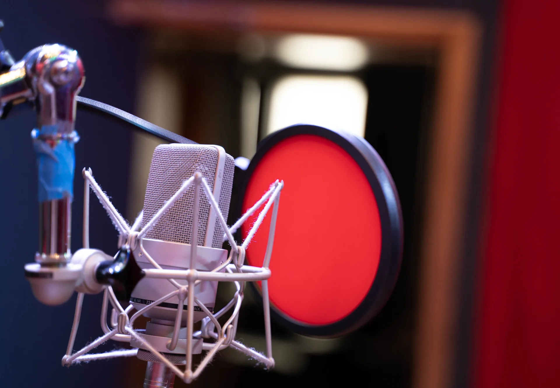 Neumann condenser mic with red pop filter in the Sonic-Rocket live room