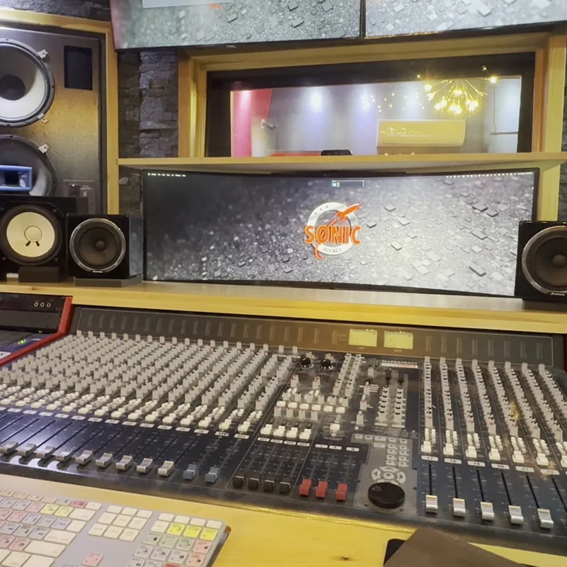 Mixing console in the Sonic Studio control room, Sonic-Rocket logo on the screen