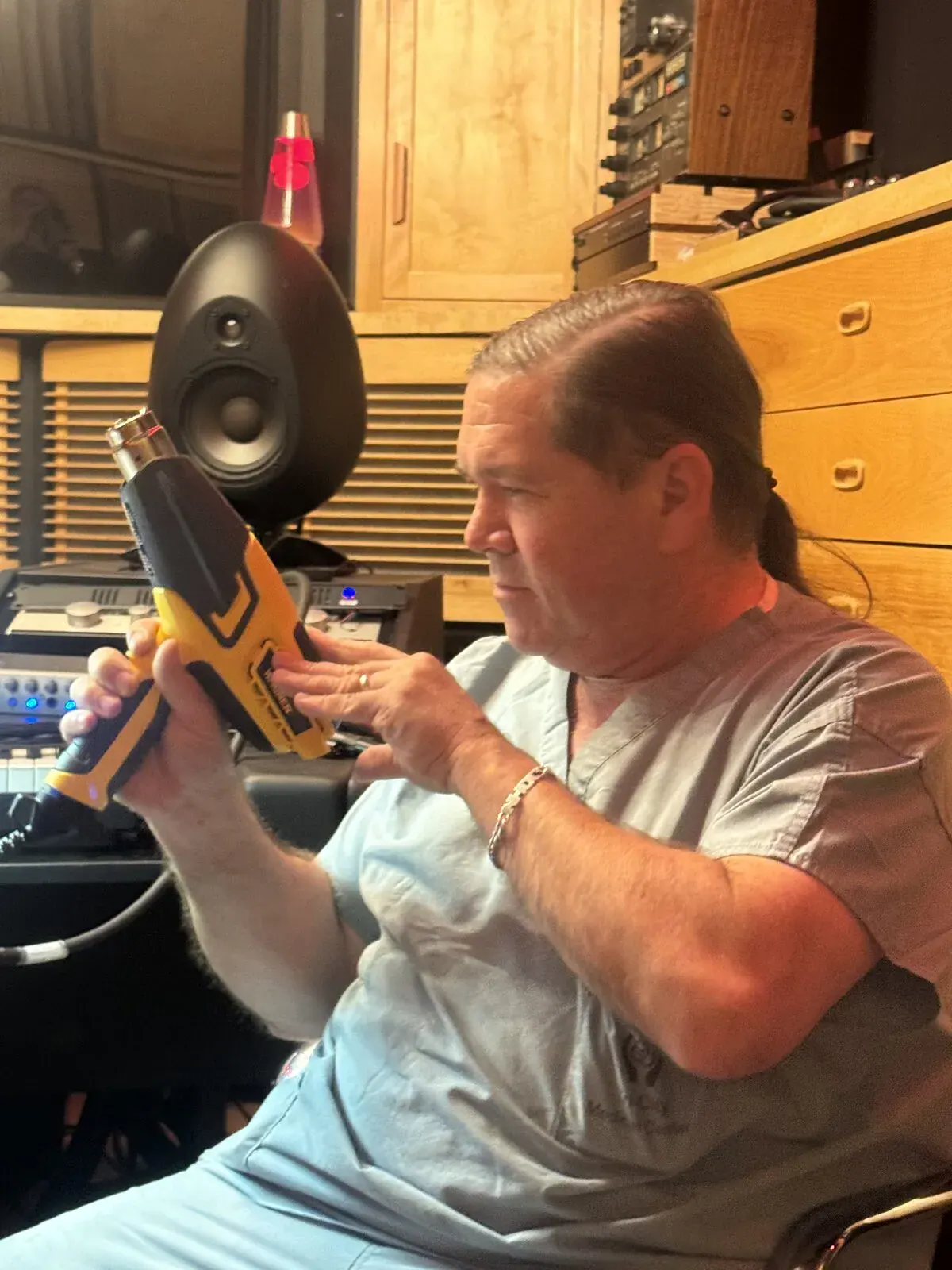 John Saccoman repairing gear with a heat gun in the Sonic-Rocket Shuttle Bay